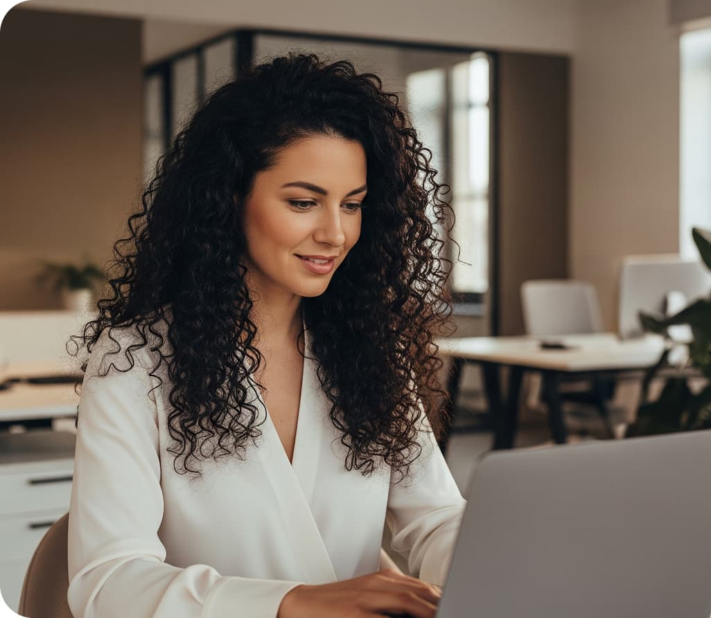 A professional woman working securely on a laptop with Hexnode Unified Endpoint Management solution, emphasizing remote productivity.
